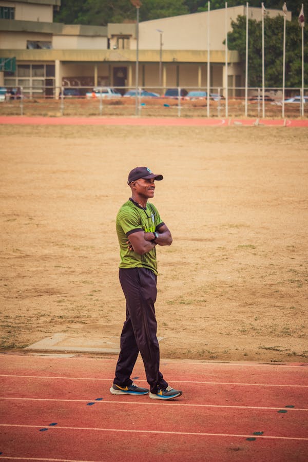 Running coach standing on a track during a training session.